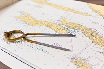 Pair of compasses for navigation on a sea map