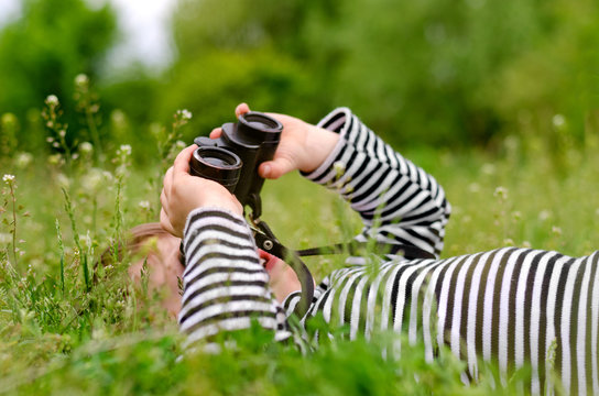 Young child using a pair of binoculars