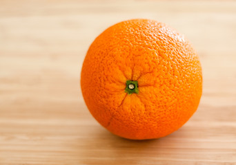 Orange on a light wooden cutting board