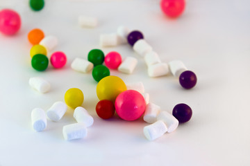 Candies, chocolate, marshmallows on white