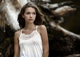 a beautiful girl near an old tree