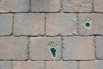 Pavement with footprints, background, texture