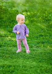 Cute funny baby girl on grass