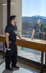 Strong good looking health care worker standing next to a large