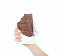 Hand holding chocolate bar in foil