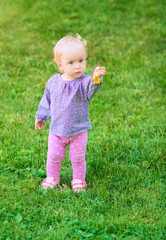 Funny cute baby girl with flower