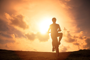 The silhouette of mountain bicycle rider on the hill