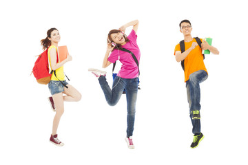 Fototapeta premium happy students listening music and jumping with books