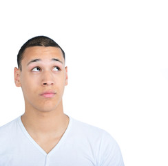 Portrait of happy young man looking up against white background