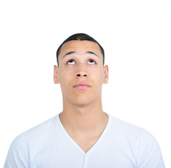 Fototapeta premium Portrait of young man looking up against white background