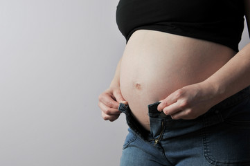 Pregnant woman no longer fitting into her jeans