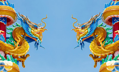 Fototapeta na wymiar Double golden dragon statue on blue sky background