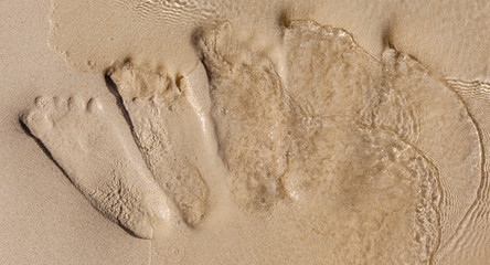 Footprints on beach were dissolved by the ocean water