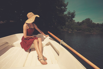 Woman in rowing boat looking at lake