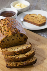 Date Loaf on Cutting Board with condiments Vertical