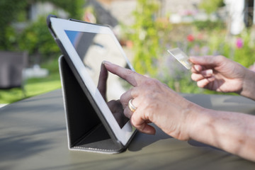 Woman senior using credit card and tablet pc to shop online