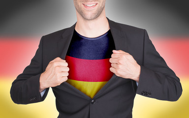 Businessman opening suit to reveal shirt with flag