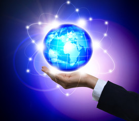 Man holding a glowing earth globe in his hands