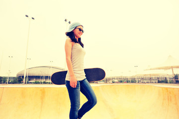 skateboarder walking at modern skatepark