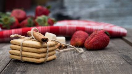 Biscuits with strawberry on the wooden table