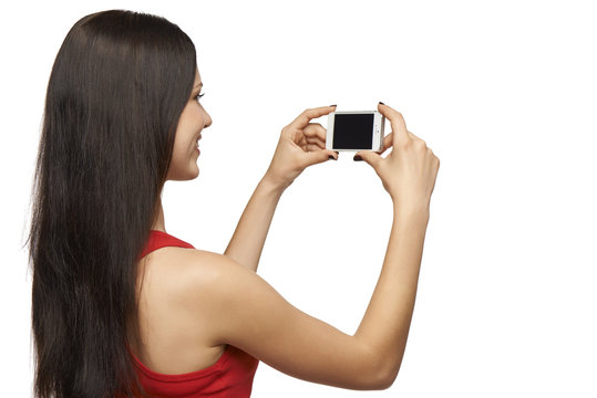 Back view of woman taking photo through cell phone