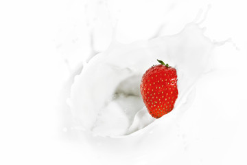 Red strawberry falling into the milky splash - 66426454