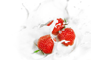 Red strawberry fruits falling into the milky splash - 66426457