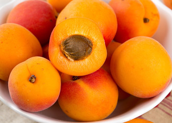 apricots in a bowl on wooden table