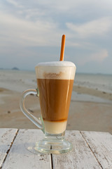 cup of hot coffee with sea background
