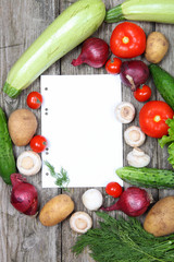 Fresh vegetables and paper for recipe