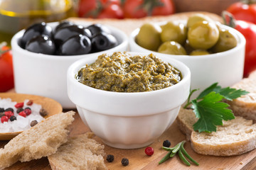 assortment of antipasti - pesto, olives, fresh vegetables