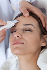 Obraz na płótnie Canvas Woman receiving facial rejuvenating treatments
