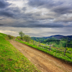Fototapeta premium fence on hillside meadow in mountain