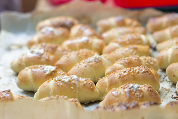 Stack of freshly baked golden mini croissants in a baking pan