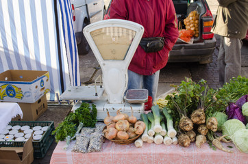 vegetable lying on market stall near retro scales