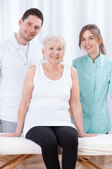 Elderly lady with her physiotherapists