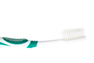 Green worn toothbrush on isolated white background