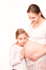 Happy child holding belly of pregnant woman