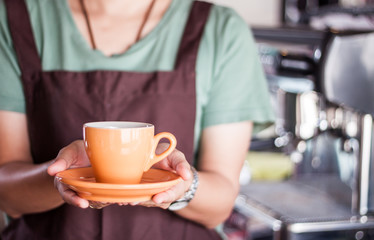 Barista presents freshly brewed coffee