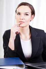 Businesswoman in an office contemplateing