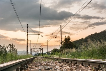 Fototapeta na wymiar Railroad tracks with a setting sun