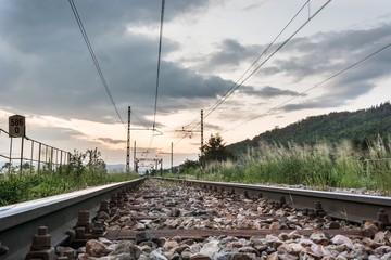 Fototapeta na wymiar Railroad tracks with a setting sun