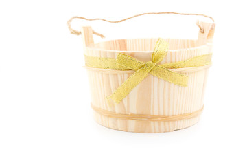 Wood vase bucket gift with golden ribbon isolated on white