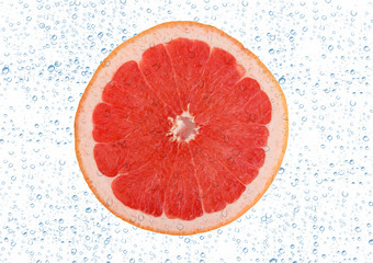 Slice of grapefruit with drop on white background