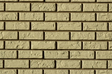 Wall made of decorative grey bricks with dark seams