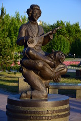 Monument featuring a musician sitting on another man's neck