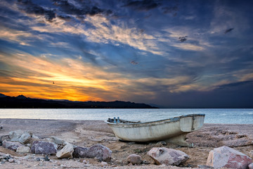 Lonely fishing boat beached at the Red Sea