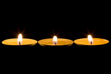 three burning tea candles