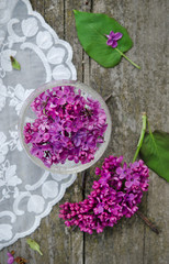 Fresh flowers of lilac on wooden background