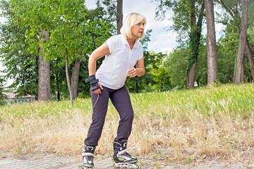 Woman in-line skating in a city park